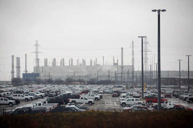 Vehicles sit parked outside of the General Motors Oshawa assembly plant in Oshawa, Ont.