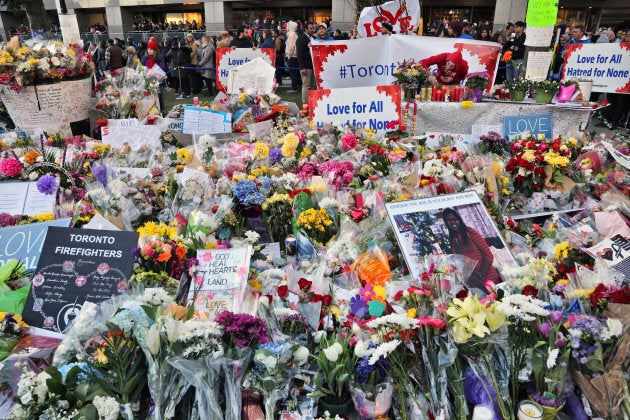 Flowers and messages at a memorial during an inter-faith vigil at Nathan Phillips Square in memory of the 10 people killed and 16 people after the deadly van attack.