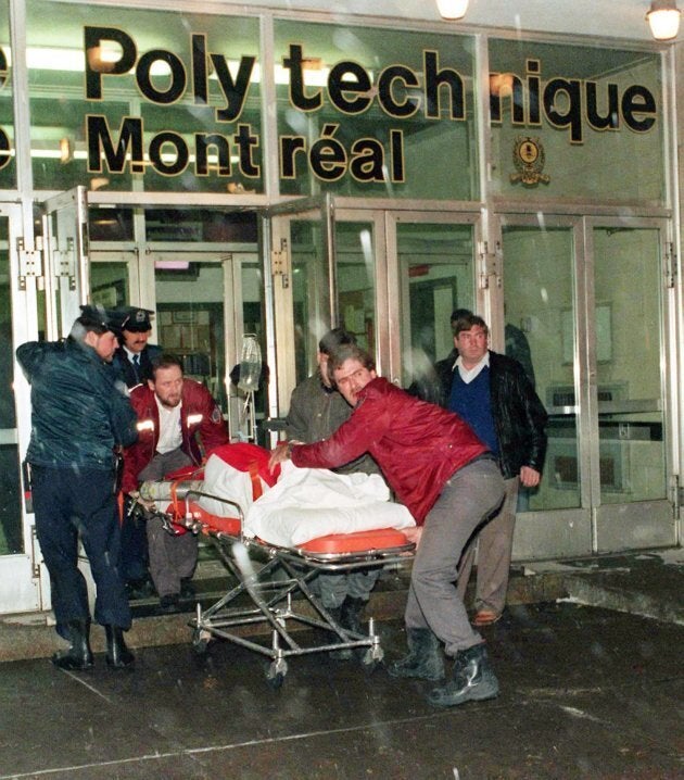 An injured person is wheeled away from the Université de Montréal after a gunman opened fire in a packed classroom in Montreal on Dec. 6, 1989.