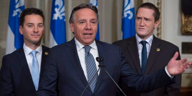 In this Oct. 19, 2016, photo, Quebec Premier Francois Legault, then the leader of CAQ, is flanked by MNAs Simon Jolin-Barrette, left, and Benoit Charrette at a news conference at the legislature in Quebec City.