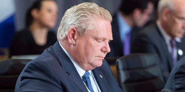 Premier Doug Ford read his notes during the first ministers meeting in Montreal on Dec. 7, 2018.