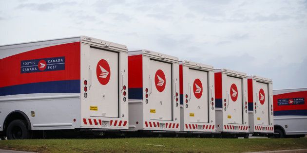 Canada Post trucks sit idle during the strike in Toronto, Ont. on Oct. 23, 2018.