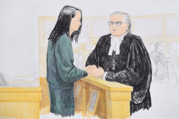 Meng Wanzhou speaks to her lawyer David Martin during a bail hearing at B.C. Supreme Court in Vancouver, on Dec. 10, 2018.