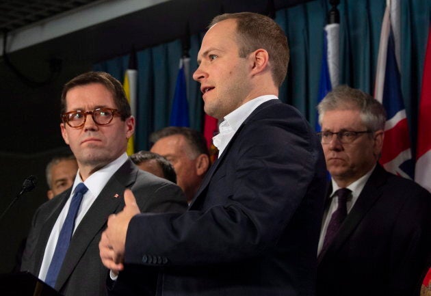 Standing Committee on Access to Information, Privacy and Ethics Chair Bob Zimmer (left) and Deputy-Chair Charlie Angus (right) look on as deputy-chair Nathaniel Erskine-Smith speaks during a news conference in Ottawa on Dec. 11, 2018.