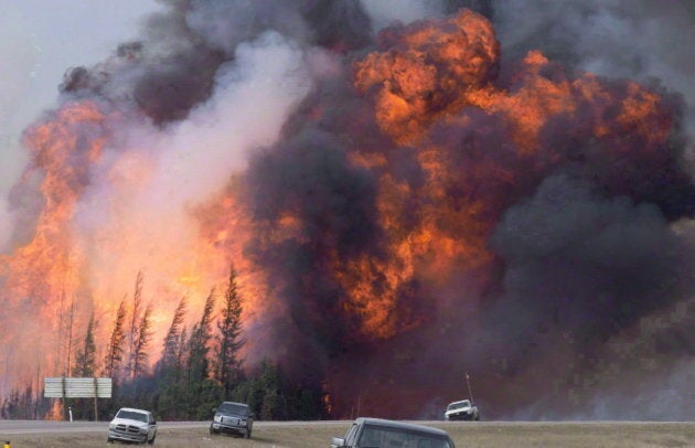 A wildfire rips through the forest by Highway 63, 16 kilometres south of Fort McMurray, Alta. on May 7, 2016.