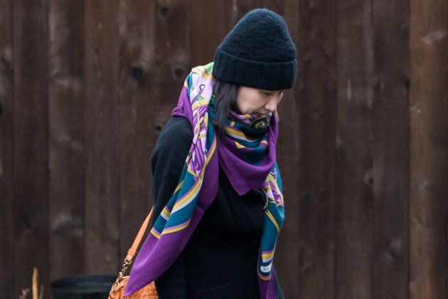 Meng Wanzhou, Huawei's chief financial officer, leaves her home under the supervision of security in Vancouver on Dec. 12, 2018.
