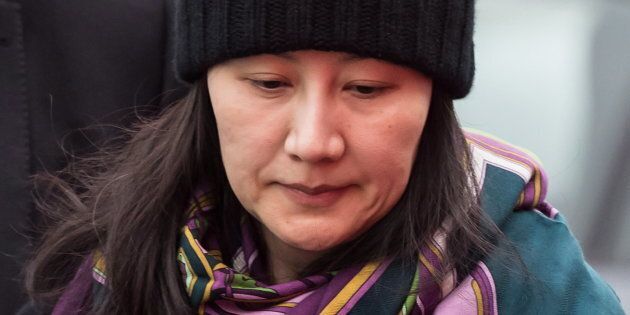 Huawei chief financial officer Meng Wanzhou is escorted by her private security detail while arriving at a parole office, in Vancouver, Wed. Dec. 12. Meng's arrest could have an unexpected casualty: Vancouver's already struggling housing market.