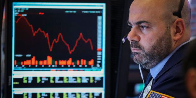 A trader works at his desk at the closing bell on the floor of the New York Stock Exchange (NYSE), Dec. 17, 2018. The Dow Jones industrial average was down over 500 points for the day at the close on Monday.