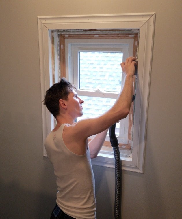 A most unflattering shot of me sanding the new window frames I built for the attic.