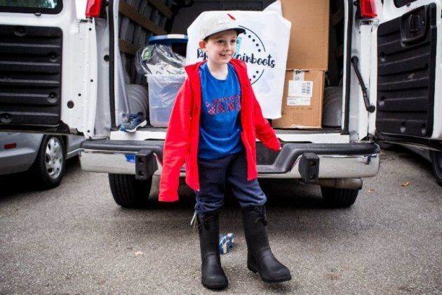 Ryder Moore poses in a pair of rain boots.