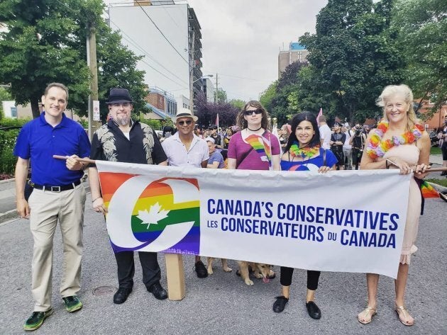 Ontario MPP Goldie Ghamari marches in a Pride parade with a banner representing the Conservative Party of Canada.