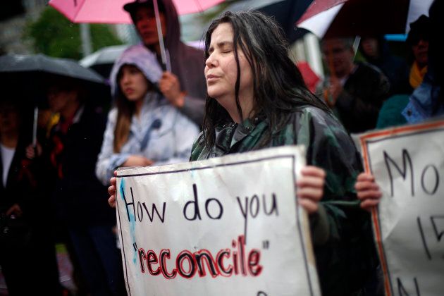 Cathy Stronghearted Woman listens during a drum circle at Queen's Park in the Walk for Reconciliation in Toronto, May 31, 2015. It was one of several such events across Canada on Sunday leading up to the Truth and Reconciliation Commission's report.
