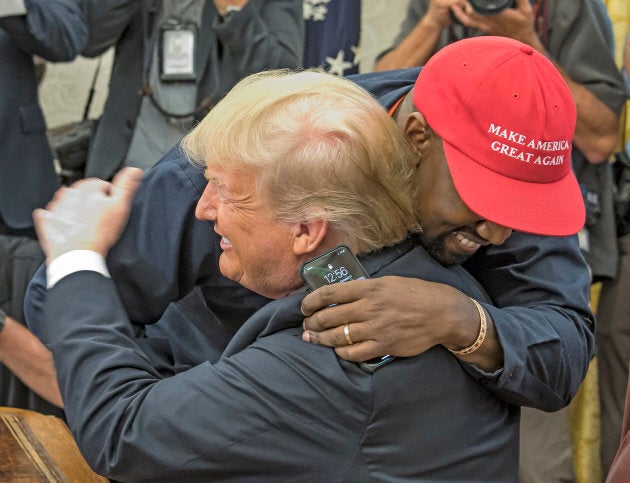 American rapper and producer Kanye West embraces U.S. President Donald Trump in the White House's Oval Office in October 2018.