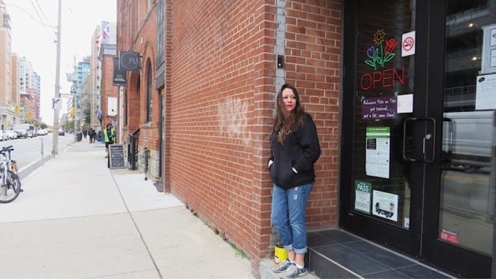 Sarah Greig, an overdose prevention worker, stands at the entrance of the Moss Park site.