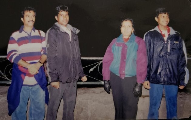 Vijay Thanigasalam, right, is seen in a 2003 photo with his parents and older brother.