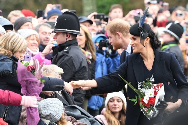 Meghan, Duchess of Sussex and Prince Harry, Duke of Sussex greet the crowds after the Royal Family's traditional Christmas service in Sandringham, Norfolk, on December 25, 2018.