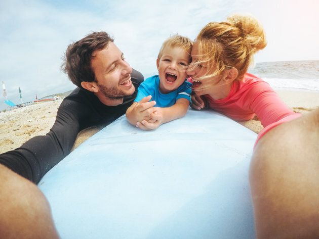 Young happy family enjoy their vacation by the seaside