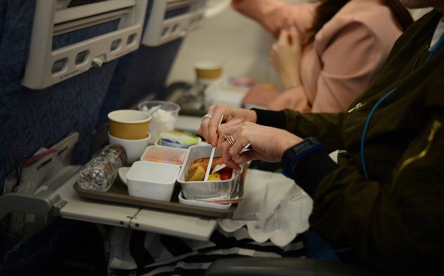 Image of passenger enjoying in-flight breakfast on board of an international flight.