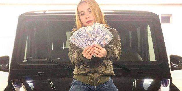 A photo of Lil Tay sitting on a luxury car, from her now deleted Instagram profile.