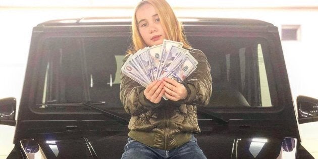 A photo of Lil Tay sitting on a luxury car, from her now deleted Instagram profile.