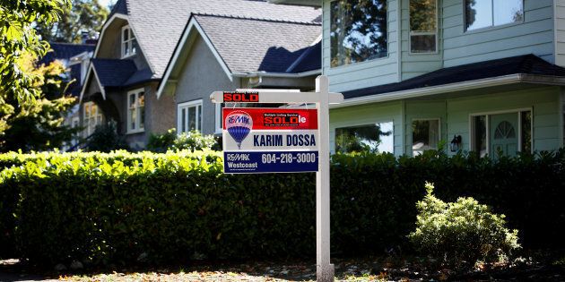 A for sale sign in front of a home in Vancouver, B.C., Sept. 22, 2016.