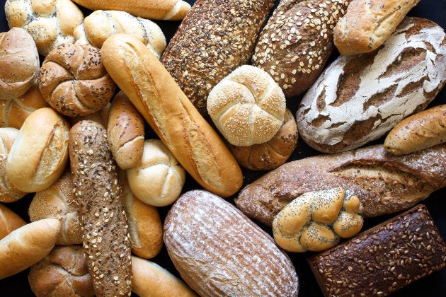 Many mixed breads and rolls shot from above.