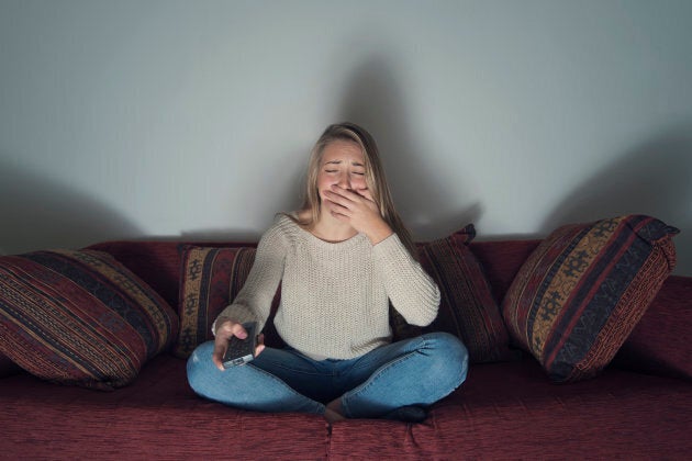 Young woman crying while watching TV