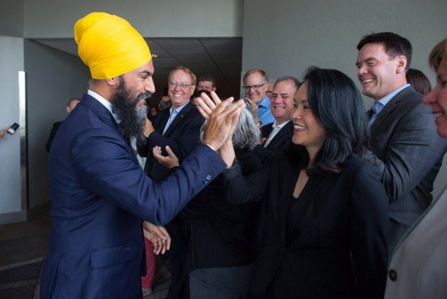 NDP Leader Jagmeet Singh, left, and MP Jenny Kwan high-five after a three-day NDP caucus national strategy session in Surrey, B.C., on Sept. 13, 2018.