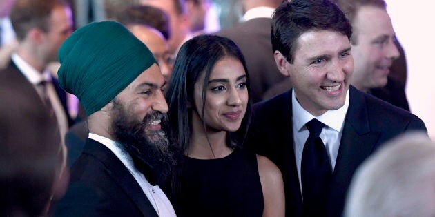 Prime Minister Justin Trudeau poses for a photo with NDP Leader Jagmeet Singh and his wife Gurkiran Singh, centre, at the Parliamentary Press Gallery Dinner at the Museum of History in Gatineau, Que., on May 26, 2018.