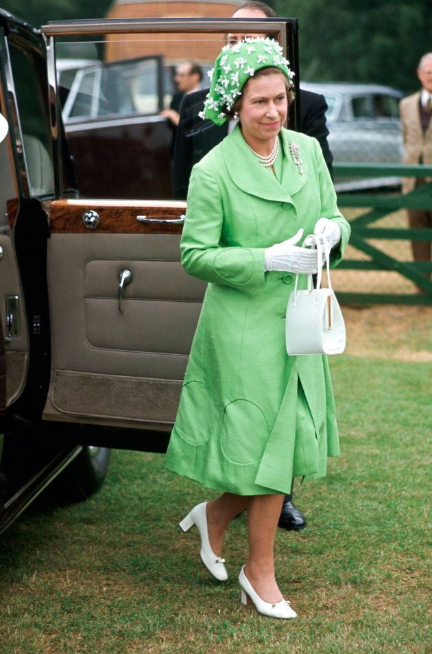 Queen Elizabeth arriving at Smiths Lawn, Windsor, after the ascot races. Her outfit is by Simone Mirman.