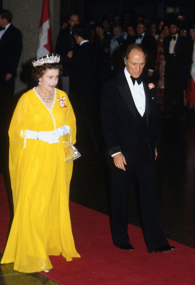Queen Elizabeth and Canadian Prime Minister Pierre Trudeau arrive to attend a banquet on October 15, 1977.