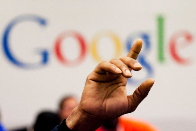 A man raises his hand during at Google offices in New York. People should have some say over the results that pop up when they conduct a search of their own name online, Europe's highest court said May 13, 2014.