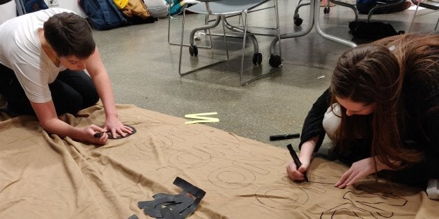 Student organizers work on a banner ahead of their event Mic Drop, a one-day activism conference held at The 519 in Toronto on Jan. 11, 2019.