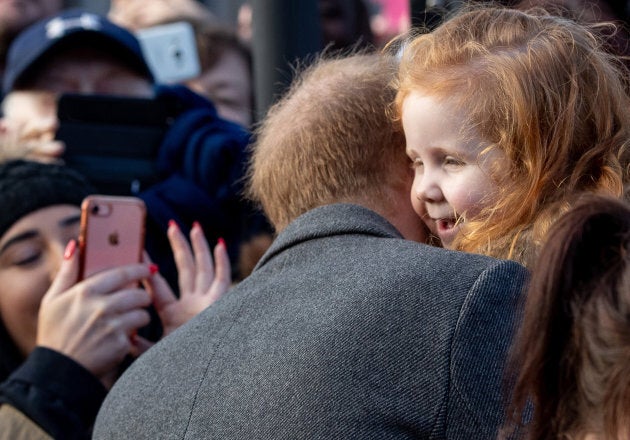 Prince Harry giving Eliza a hug.