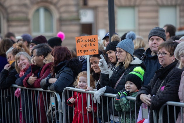 Eliza Morris hold up her "Gingers Unite" sign with a crowd of well-wishers all waiting to see Prince Harry and Meghan Markle on Monday.