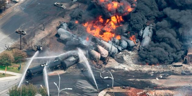 Smoke rises from railway cars that were carrying crude oil after derailing in downtown Lac-Mégantic, Que. on Sat., July 6, 2013.