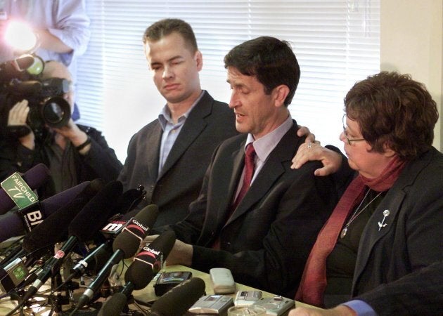 Federal NDP MP Svend Robinson is supported by his partner Max Riveron (left) and fellow MP Libby Davies (right) as he cries while admitting to shoplifting a diamond ring during a news conference in Burnaby, B.C. on April 15, 2004.