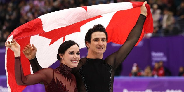 Tessa Virtue and Scott Moir of Canada celebrate during the victory ceremony for the Figure Skating Ice Dance Free Dance at the PyeongChang 2018 Winter Olympic Games.