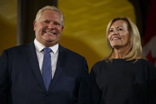 Ontario Premier Doug Ford and Christine Elliott, Ontario's deputy premier and health minister, stand together during a swearing-in ceremony in Toronto, Ontario, on June 29, 2018.