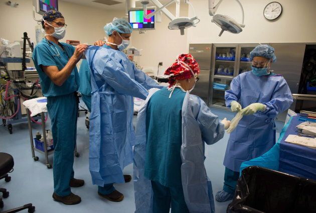 Dr. Darius Viskontas, second left, and his team prepare to remove a cyst from a male patient's knee, at the Cambie Surgery Centre, in Vancouver during 2016. Founder, Dr. Brian Day, is fighting to overturn the B.C. Medicare Protection Act.