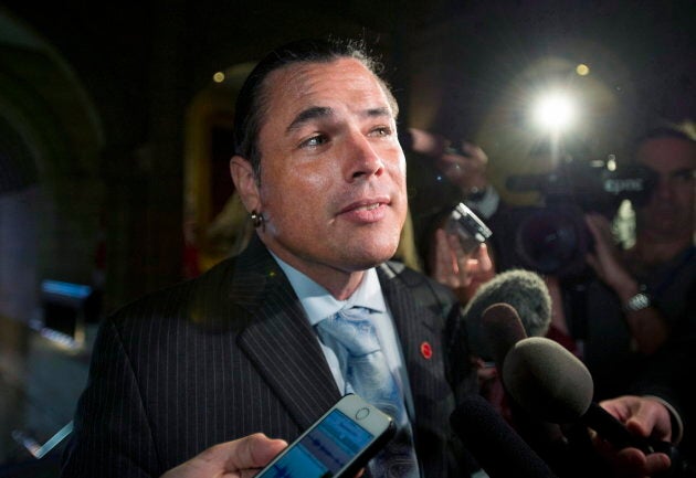 Sen. Patrick Brazeau speaks to reporters as he returns to the Senate on Sept. 27, 2016.