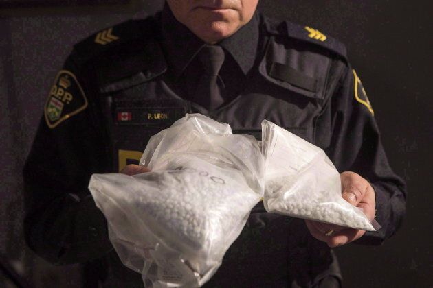 An Ontario Provincial Police officer displays bags containing fentanyl during a news conference in Vaughan, Ont., on Feb. 23, 2017.