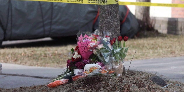 Flowers are seen outside a home in Ajax, Ont., on Mar. 15, 2018. A woman and her two children were killed in the house.