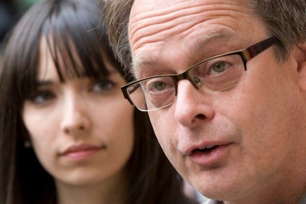 Marc Emery, the self-described "Prince of Pot" speaks to reporters outside the Supreme Court in Vancouver May 10, 2010, prior to turning himself in to be extradited to the United States as his wife Jodie, left, looks on.