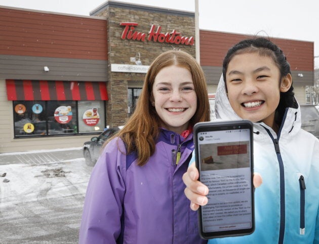 Eve Helman, left, 12 and Mya Chau, also 12, outside a Tim Hortons in Calgary on Sunday.