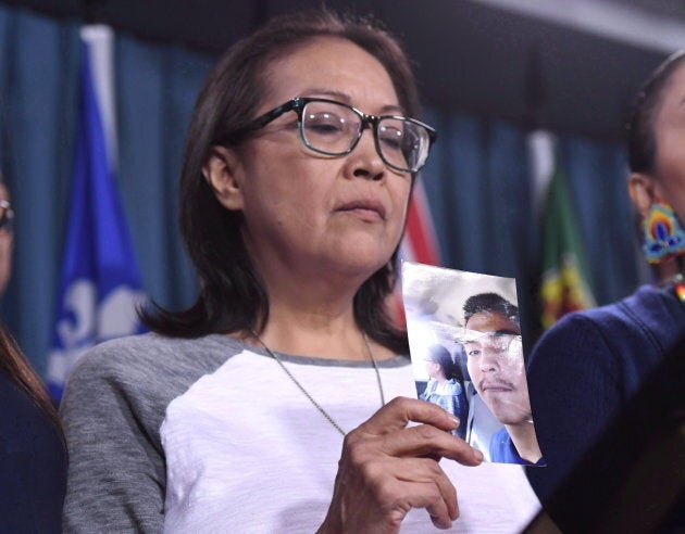 Debbie Baptiste, mother of Colten Boushie, holds a photo of her son during a press conference on Parliament Hill in Ottawa on Feb.14, 2018.