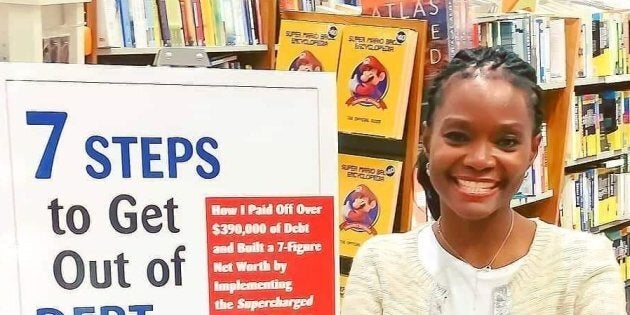 Adeola Omole is pictured next to a sign for her book,