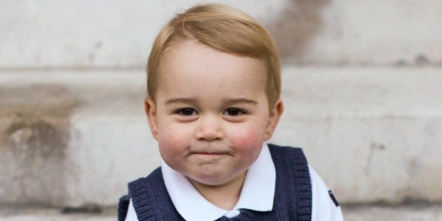 Prince George sits for his official Christmas picture in a courtyard at Kensington Palace in late Nov. 2014 in London, England.