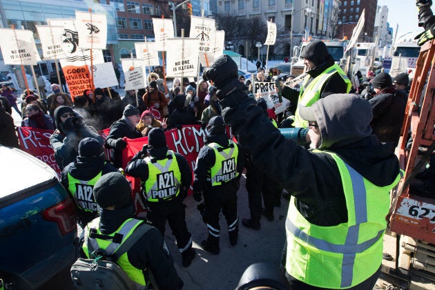 A protester and counter protesters gather during the United We Roll demonstration on Parliament Hill in Ottawa on Feb.19, 2019.