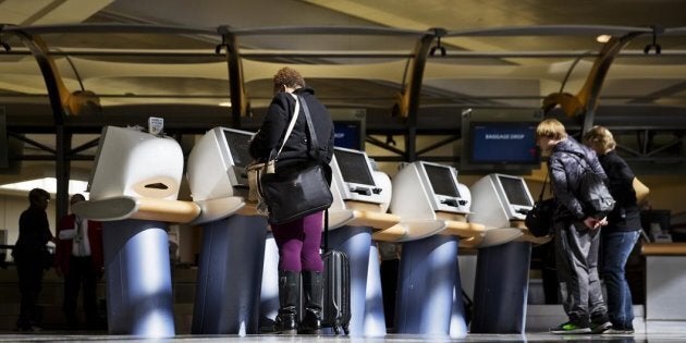 In this Jan. 30, 2017 file photo, passengers check in for Delta Air Lines flights at kiosks at Hartsfield-Jackson Atlanta International Airport in Atlanta.